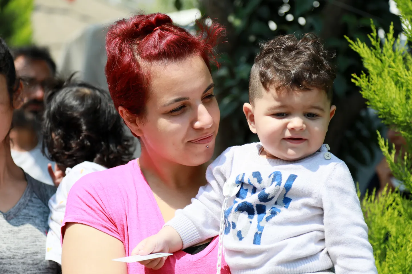 A mother and her child in the delivery line of UNICEF-supported supplies in an informal temporary accommodation shelter in a neighborhood in Hatay,&nbsp;after two devastating earthquakes hit south-east T&uuml;rkiye on 6 February 2023.