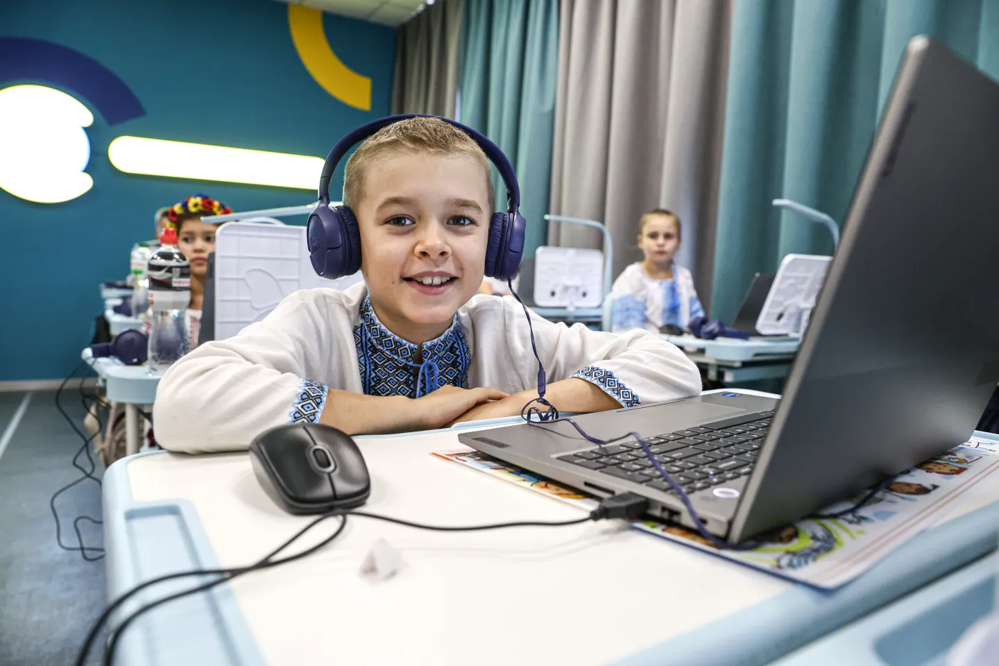 A child uses a computer in a classroom. 