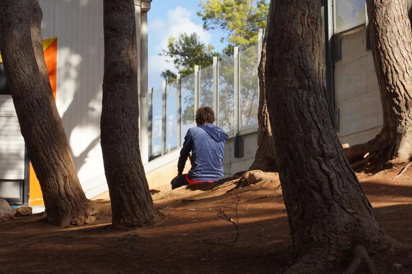A child sits alone praying at the &lsquo;hotspot&rsquo; reception centre for migrants on the island of Lampedusa, Italy.