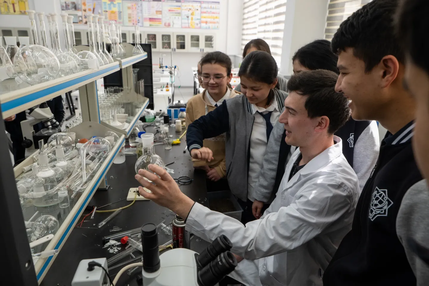Rayhona, 17, with her classmates during the chemistry classes. She is an 11th-grade student at the specialized school named after Abu Ali Ibn Sino. Students learn about the effects of multiple types of gas in different conditions.