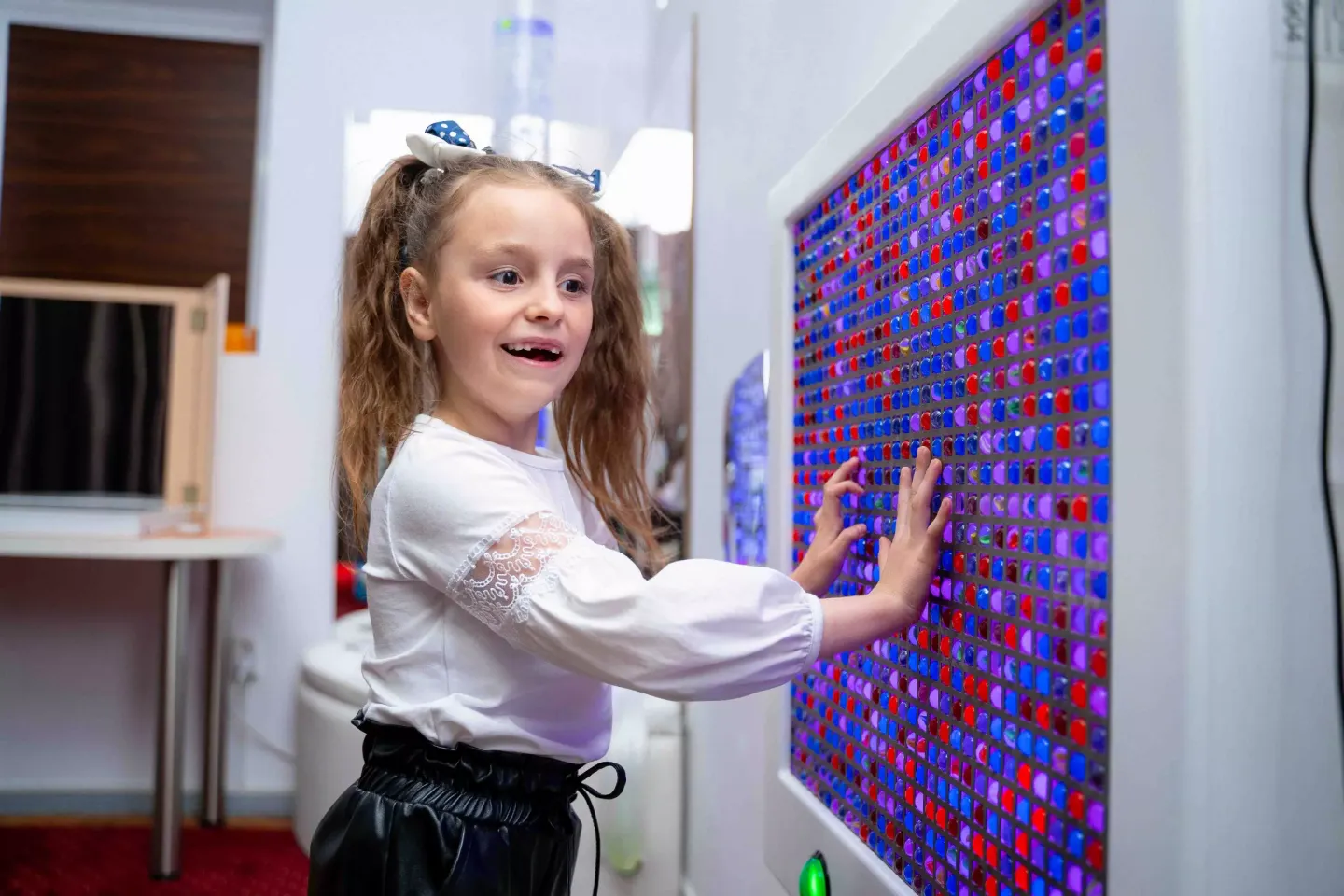 Six-year-old Valeria from Ceadir Lunga, Moldova, takes part in a therapy session in a sensory room at the Recovery Centre for Children. At  the age of two, Valeria was diagnosed with hearing impairments. Here in the unique environment of the sensory room, created by UNICEF  with support from of the Government of Japan, children can play with different materials that help them develop their sensory functions and  adapt to their surroundings. April 2024