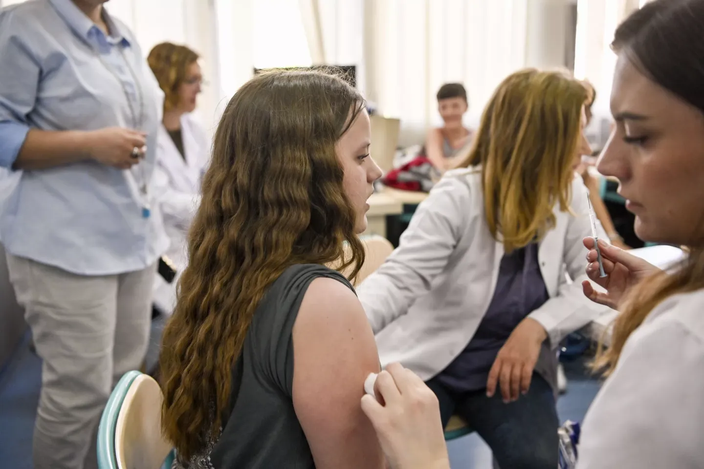 A girl receives a HPV vaccine in school in Kosovo