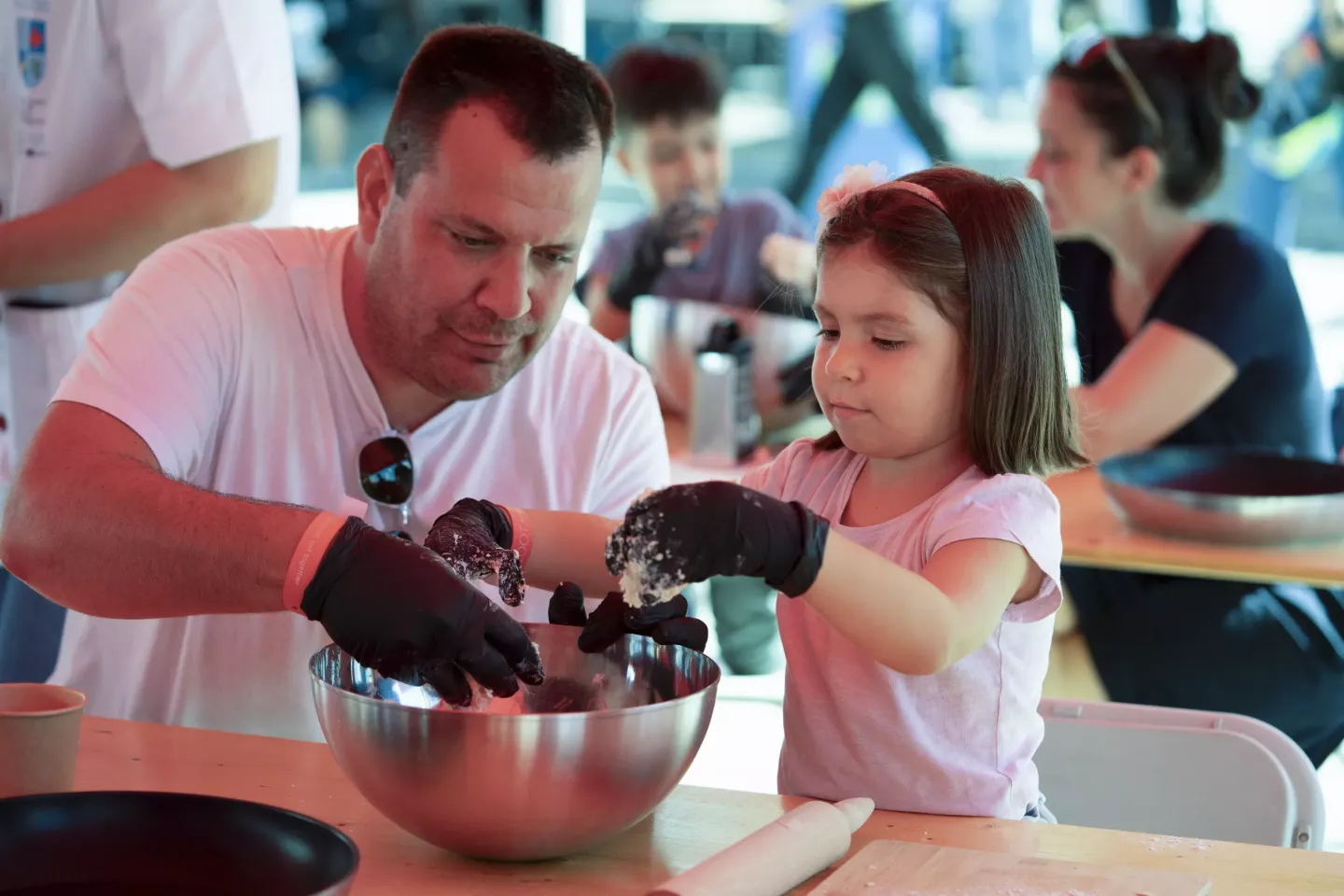 A father and daughter cook together.