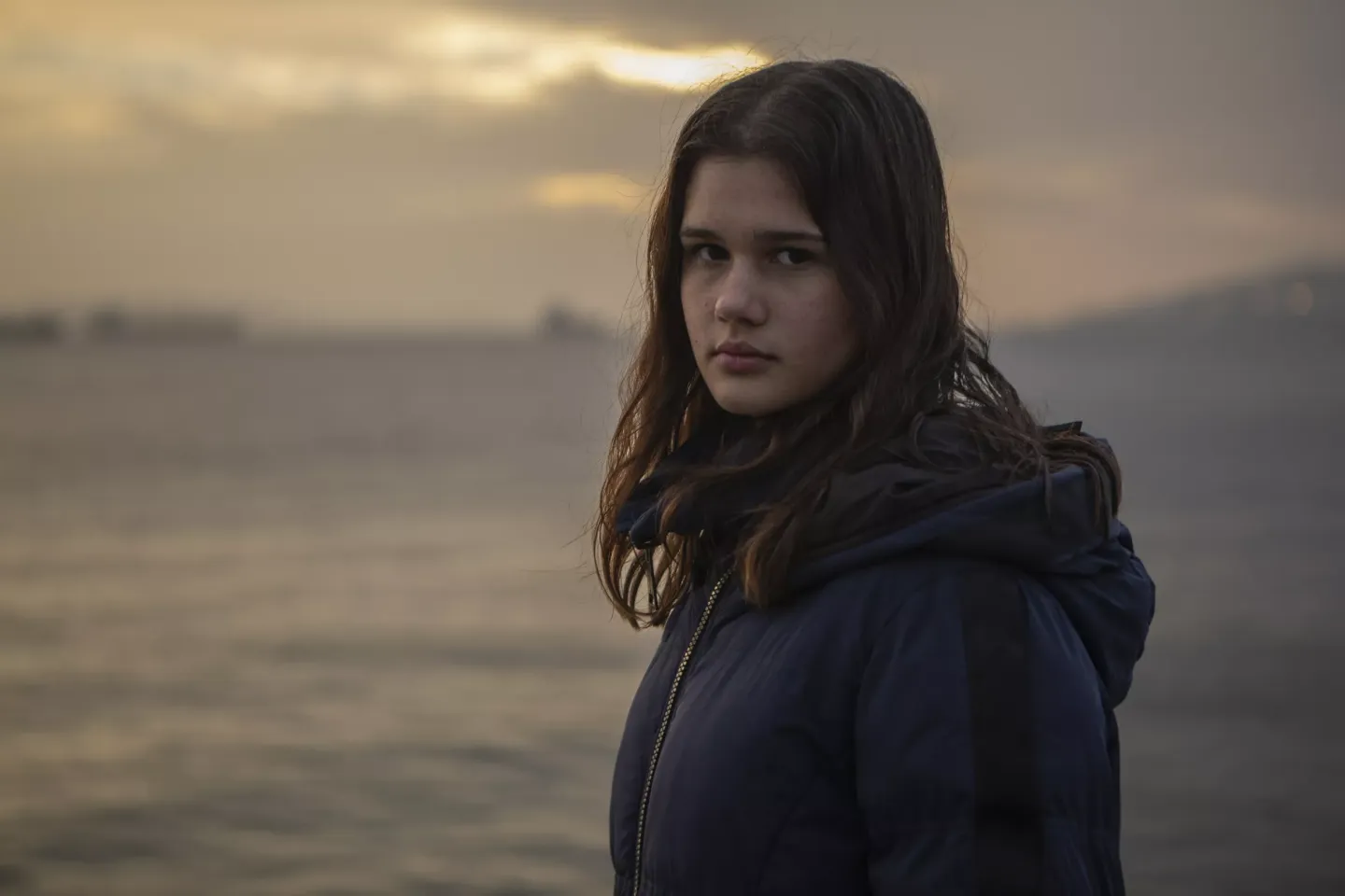 On November 12, 2024, Theodora Kosmopoulou, a 16-year-old from Greece attending COP29 in Baku, Azerbaijan, gazes over the Elefsina Gulf&mdash;the place of her origins. Elefsina, an industrialized city in the Attica region, faces severe environmental and climate challenges due to its concentration of heavy industries, including oil refineries, cement factories and manufacturing plants.