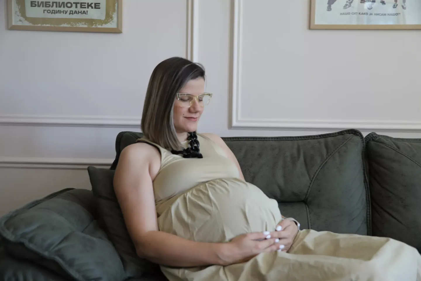 A pregnant woman holding her stomach in her home in Vrsac, Serbia, during the visitt of the home visiting nurse.