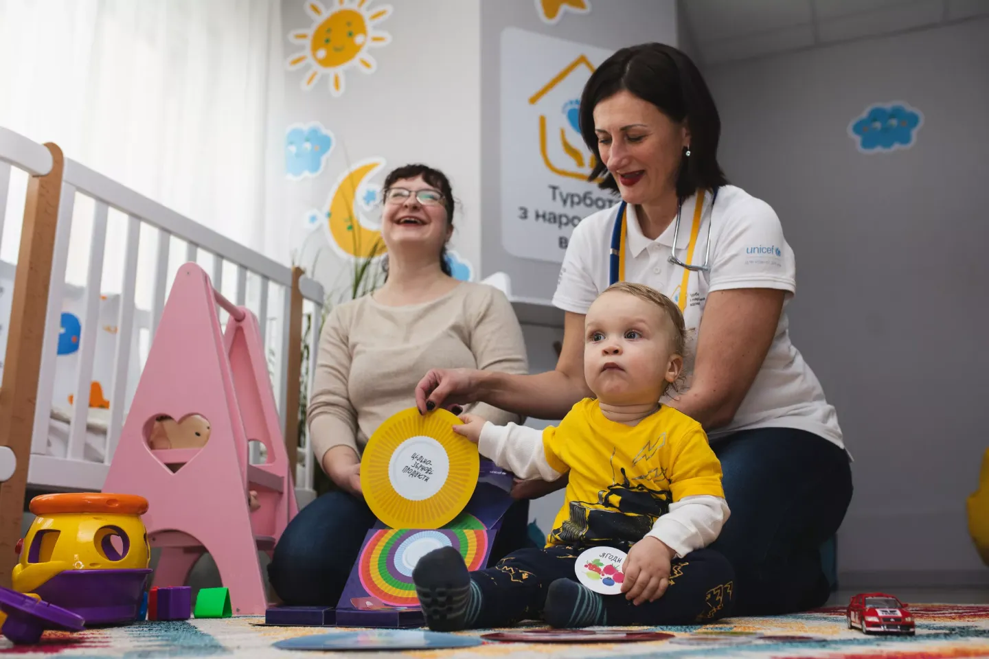 Seventeen-month-old Roman explores colourful educational materials