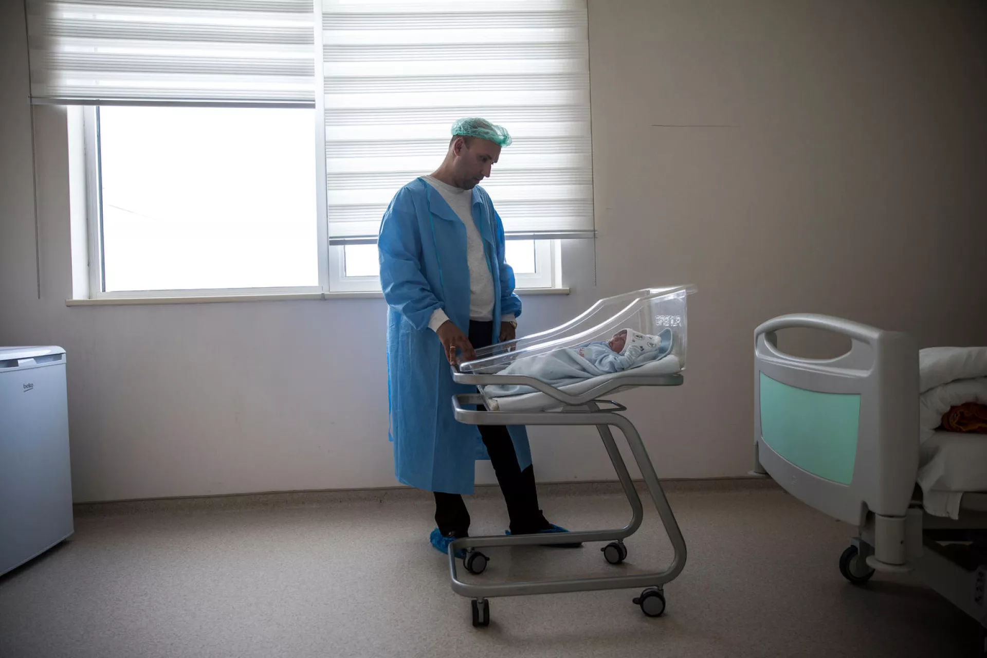 Arslan as he looked down on his newborn son Damir, who came into the world just three hours earlier at the busiest and largest mother and child health centre in Turkmenistan&rsquo;s capital Ashgabat.