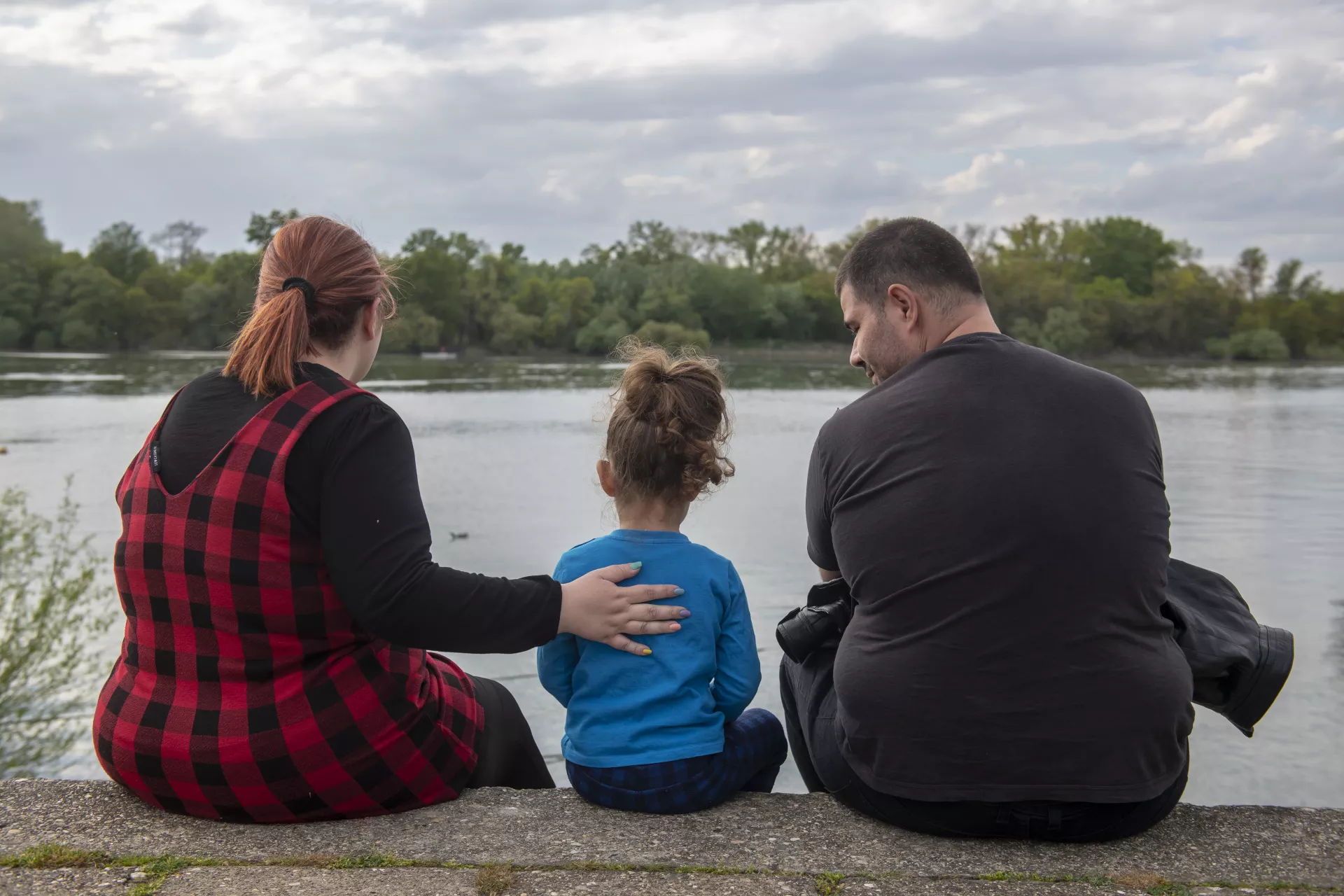 A family looks out over the water. 