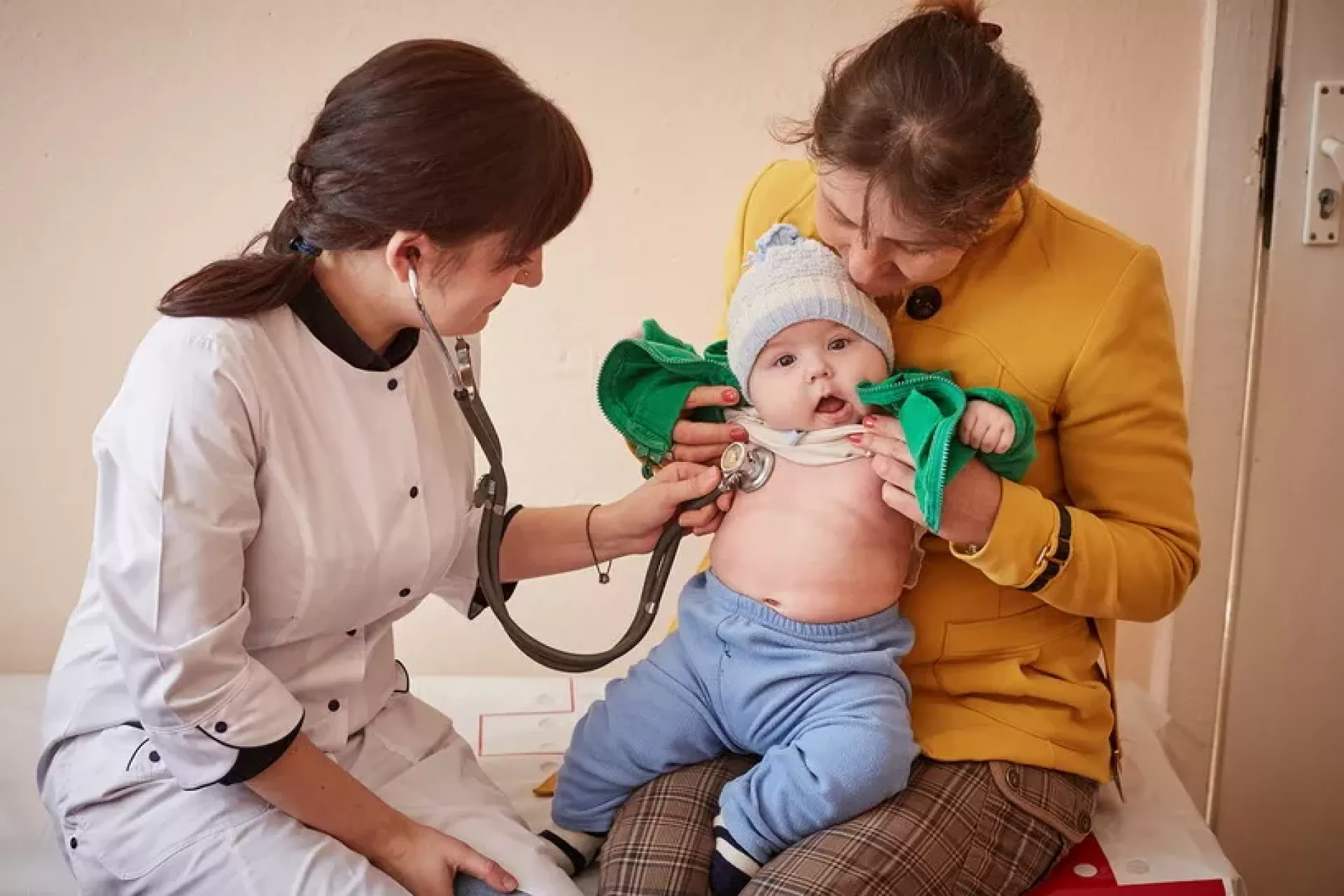 A baby gets a check-up from a doctor. He is diagnosed with whooping cough. 
