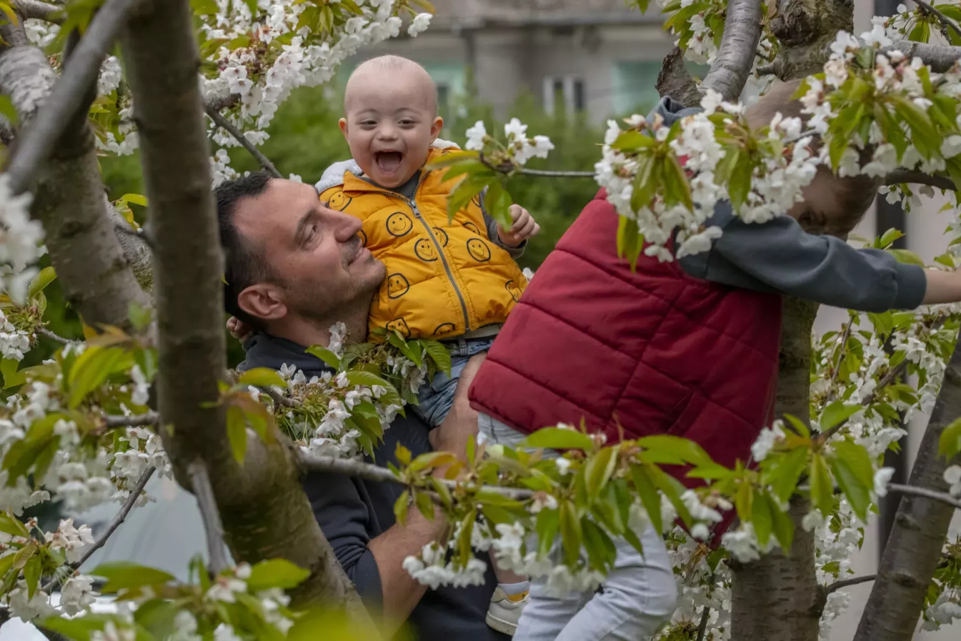 Andrija Radosavljevic (aged three) and Mateja Radosavljevic play with their father Milan Radosavljevic. Serbia. April 2022.