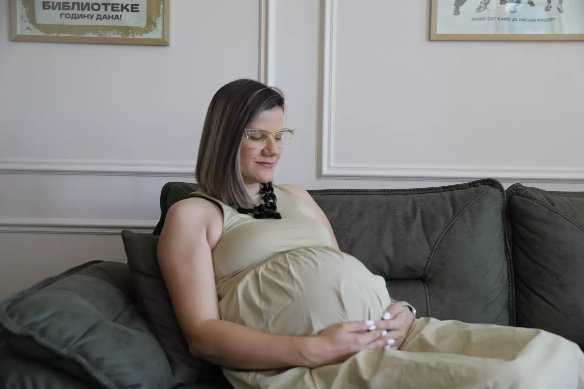 A pregnant woman holding her stomach in her home in Vrsac, Serbia, during the visitt of the home visiting nurse.