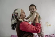 Mother holds her child in Kyrgyzstan