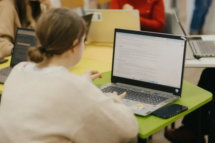 A girl types on a computer