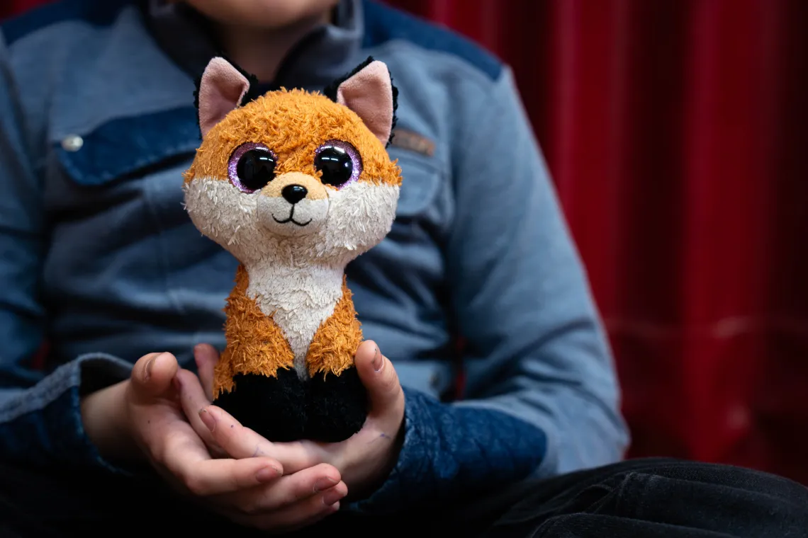 A toy fox held in Ruslam's hands.