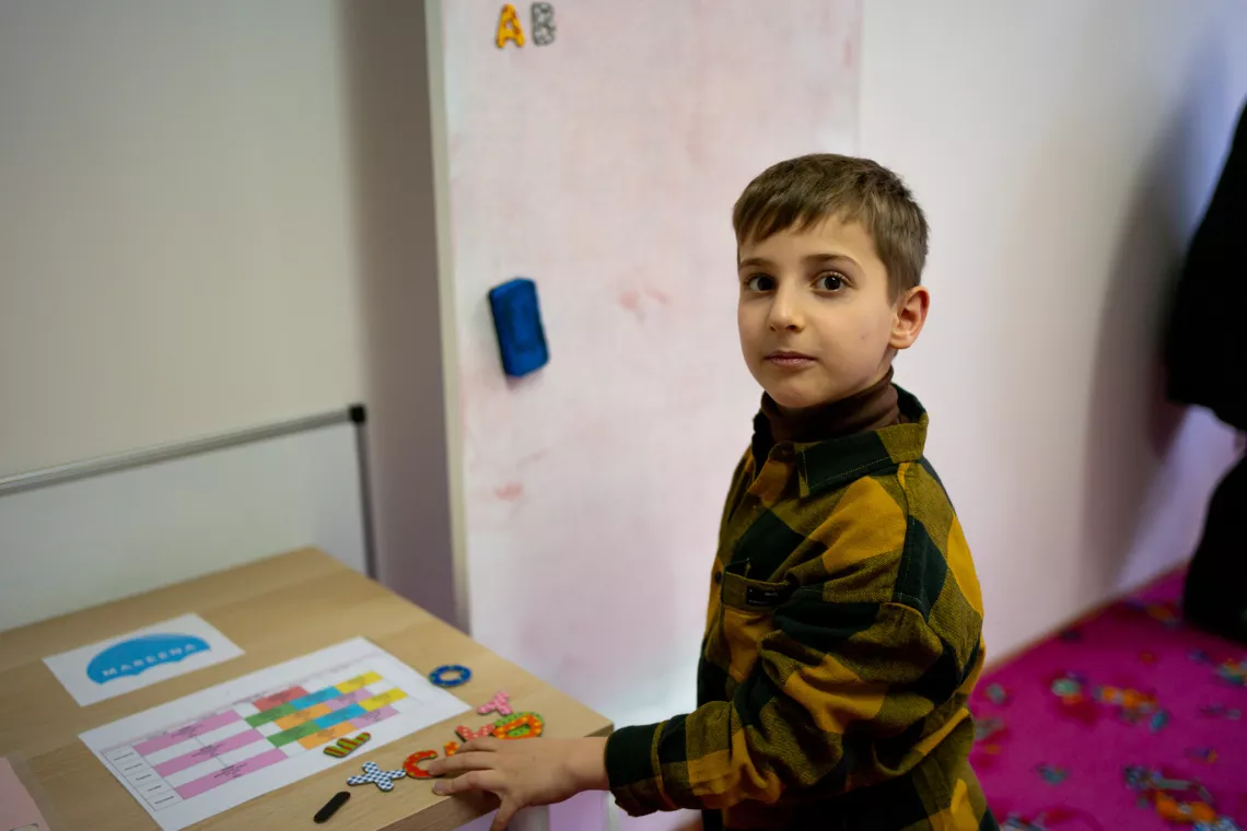 Ukrainian boy Samuel playing in the kindergarten room in Gač&iacute;kovo Humanitarian Center.