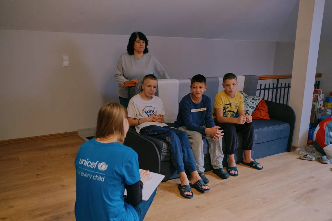 UNICEF worker talks with children inside the home