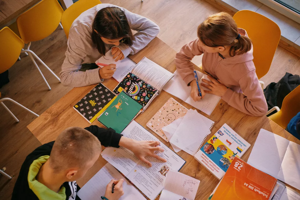 Group of children doing their homework in the house
