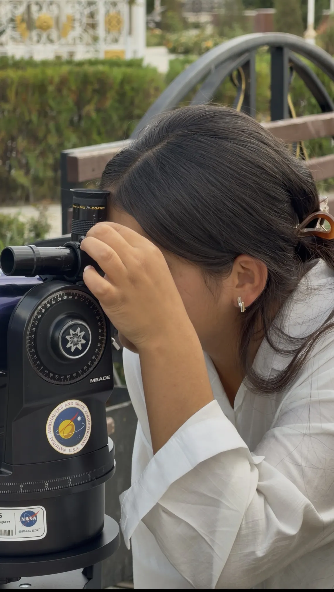 Sumaya is looking through a telescope