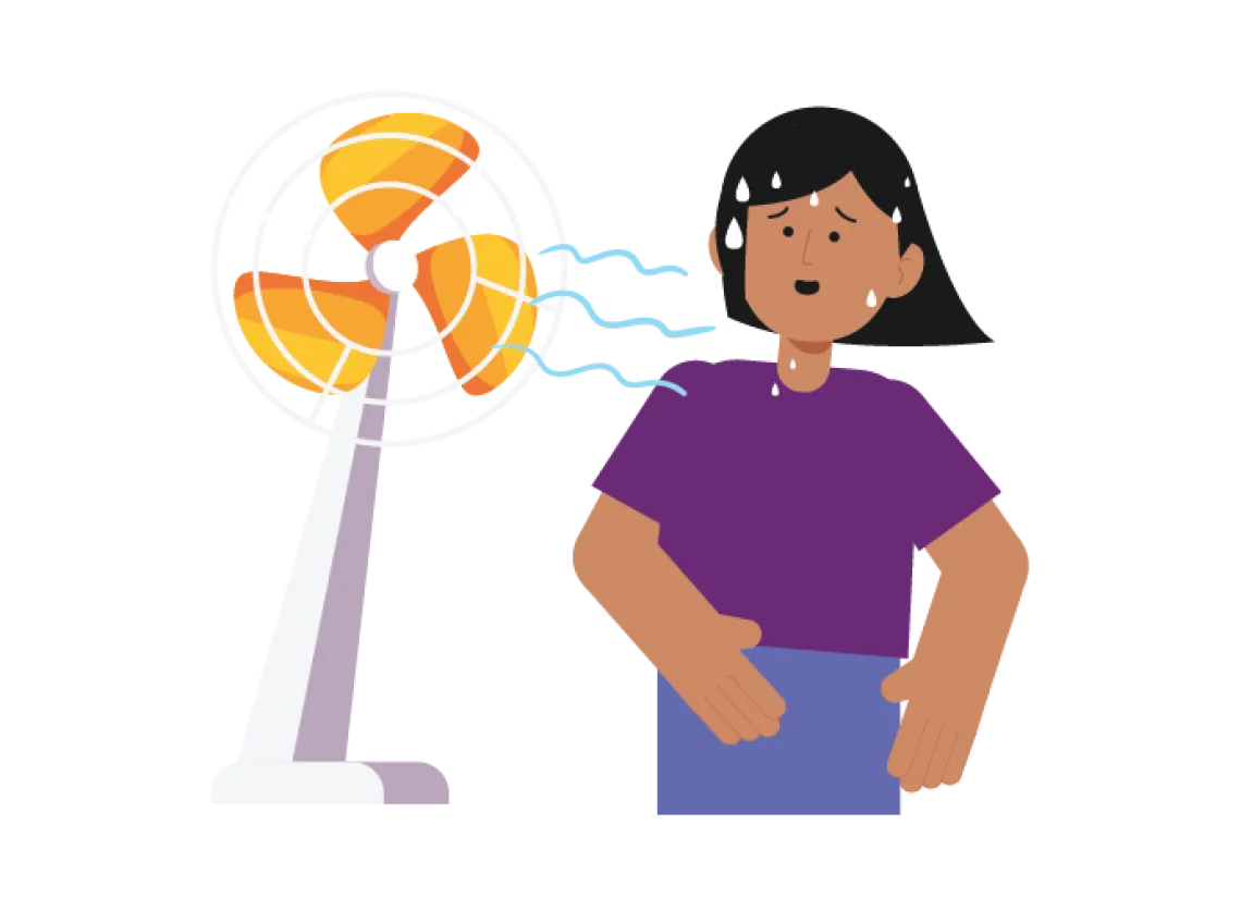 How to prepare for a heatwave: A girl stands next to a fan