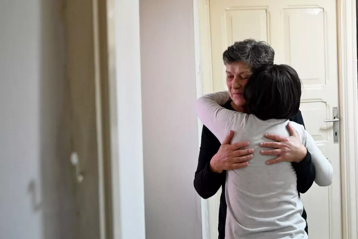Elpiniki hugs her foster child at their home in Krushevo,  North Macedonia. &ldquo;I would recommend to everyone, if  they have sincere desire, to foster a child, to provide them  with a warm home, family and, above all, love.&rdquo; May 2023.