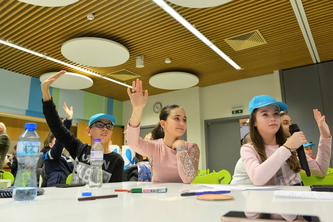 Children raising hands to participate in the "Protection" round of the workshop on Safer Internet Day, Sofia, Bulgaria.