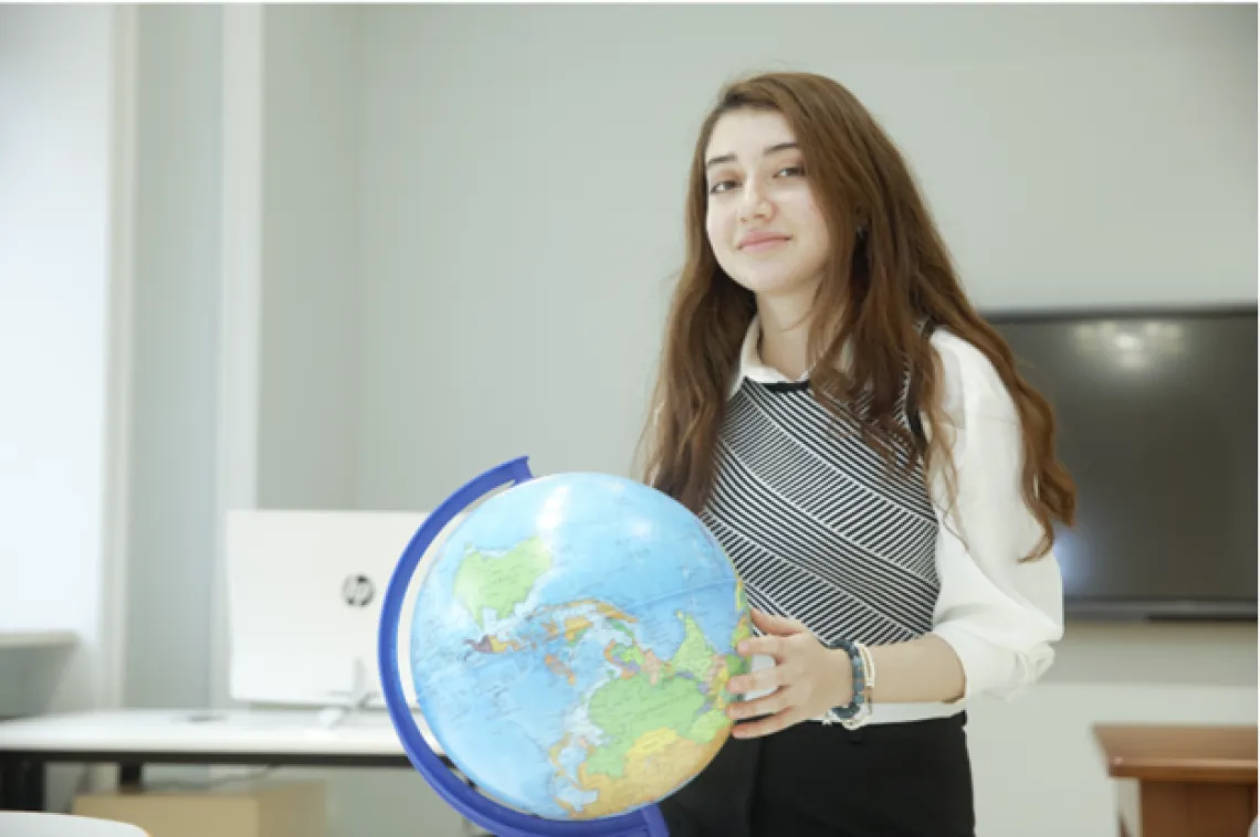 a young person with a globe