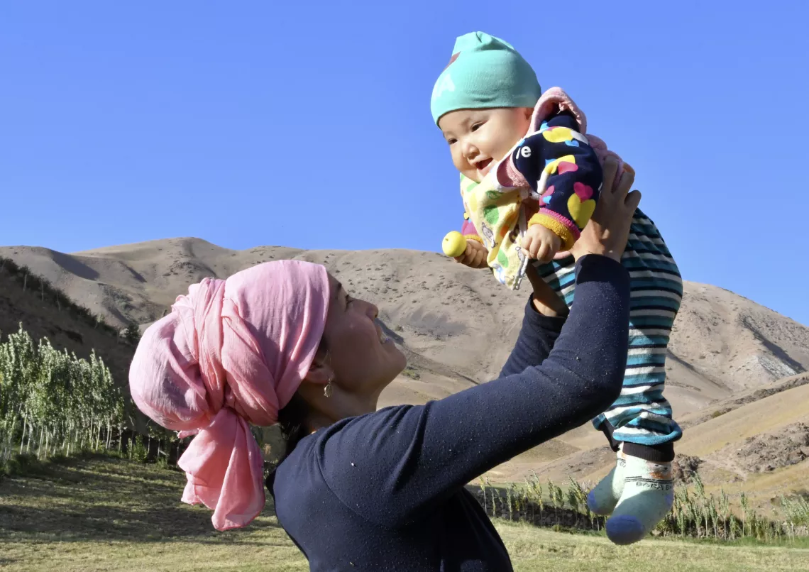 Mother holds her baby in Osh, Kyrgyzstan.