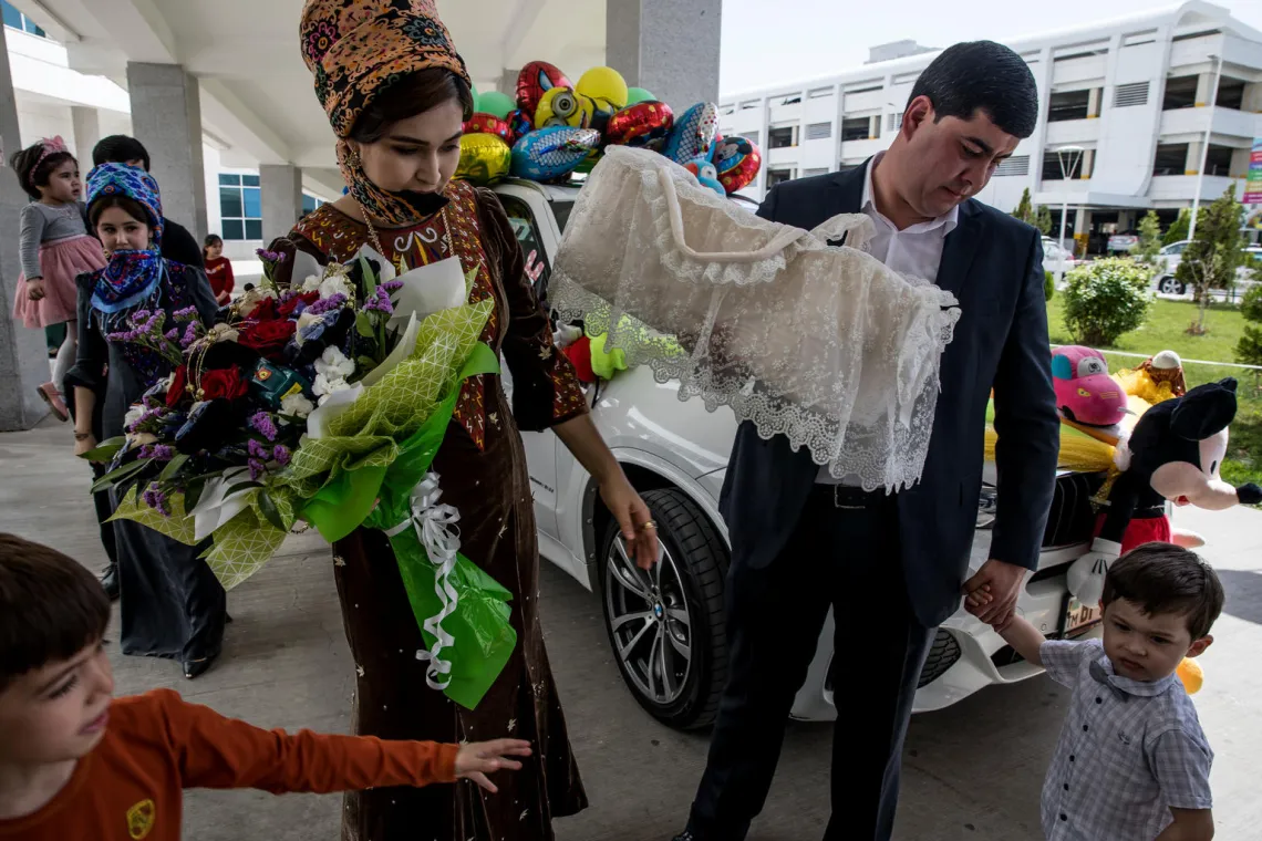 In addition to dressing himself in his smartest attire, Eziz, a new father taking part in the 'bringing the baby' home ritual, has also had his car dressed &ndash; making it the most flamboyant of sights. 