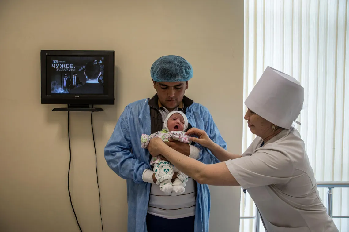 A father holds his new baby at a maternity centre in Ashgabt, Turkmenistan.