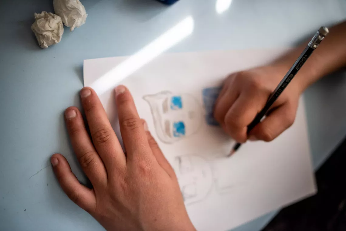 Liza draws a picture while visiting the shelter.