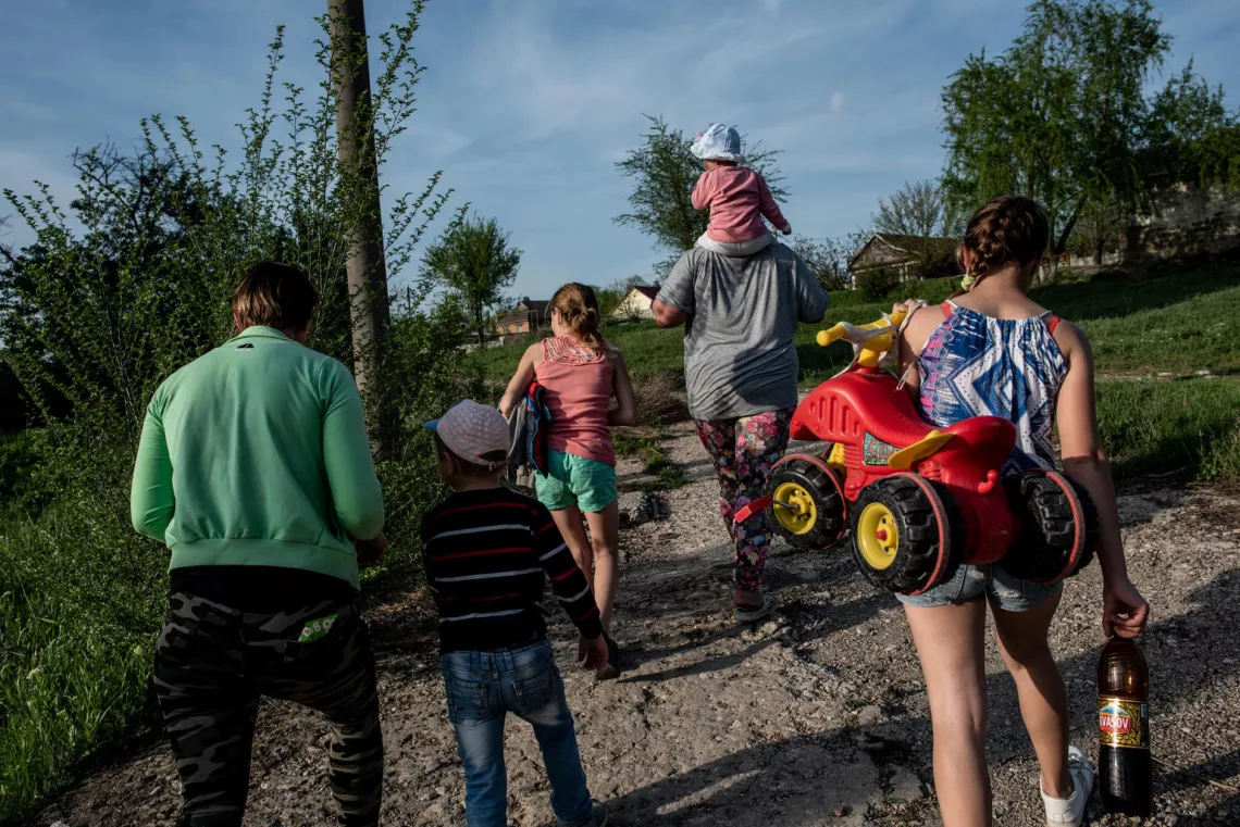 Silvia, Liza, Lillia and Vlad walk with friends close to home. Silvia says that she is hopeful her children will have a better life than her.
