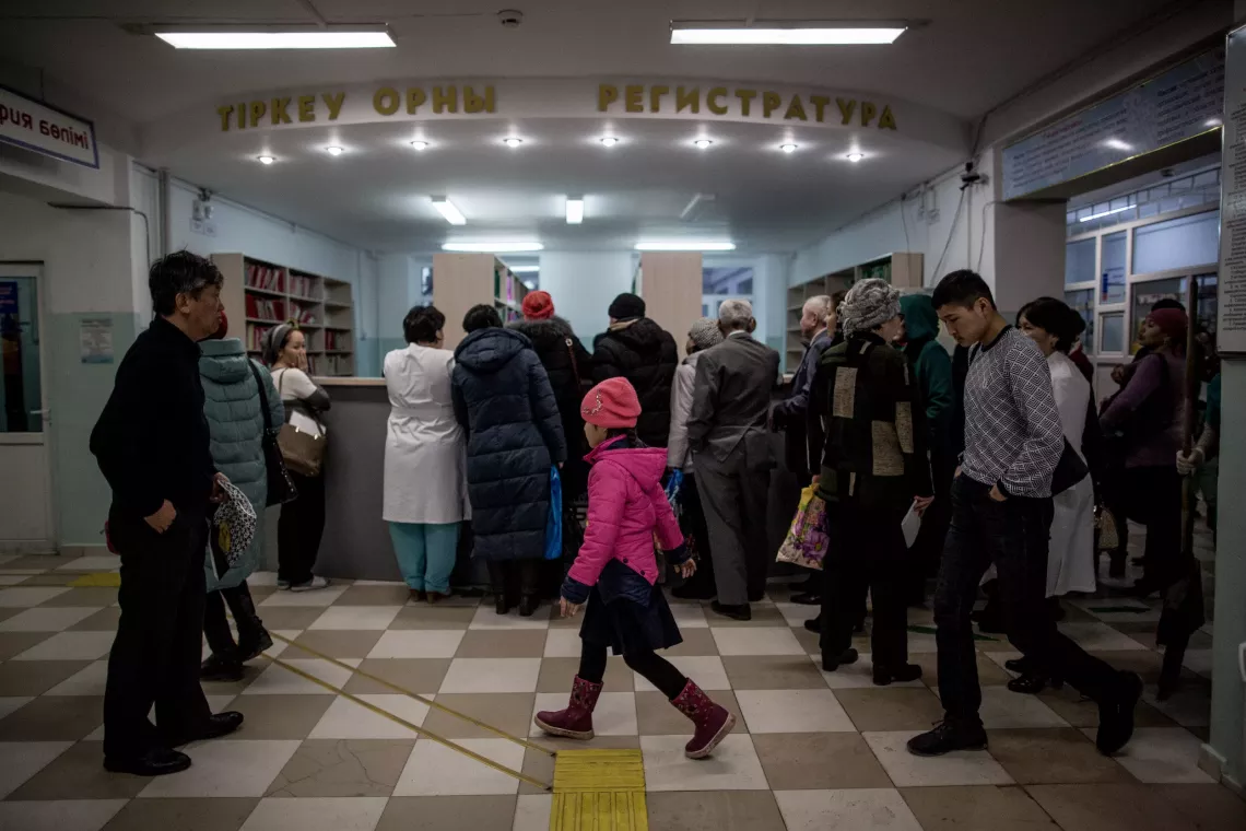 A girl walks across the entrance to polyclinic #6 in Kyzylorda, Kazakhstan. In Kazakhstan, every second child between 2-14   is subjected to violence in the family, and UNICEF works to help front-line service providers identify and refer suspected cases  of violence. March 2018.