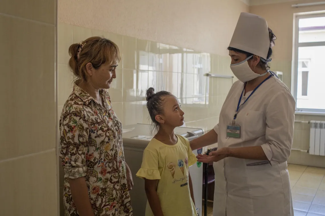A girl listens to her Vaccination Nurse