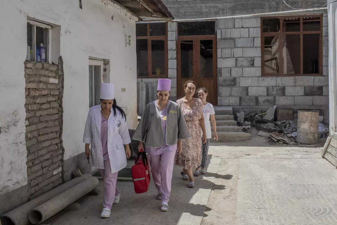 Dilbar Boltaeva (left), 50, Chief Physician at Samarkand City Family Clinic #2, Patronage Nurse Parvina Khaydarova (second from left), 27, walk with Leila Sultanova (back right), 11, and Leila&rsquo;s mother, Mukharram Yuldasheva, 38, after visiting them at their home in Samarkand, Uzbekistan.