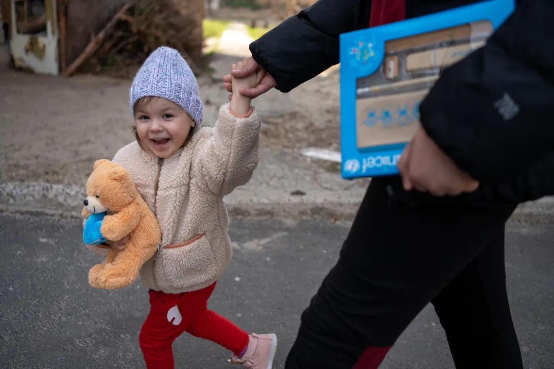 Three-year-old Diana is on a walk. usually she is forced to shelter with her family from the ongoing shelling in dark, damp basement.