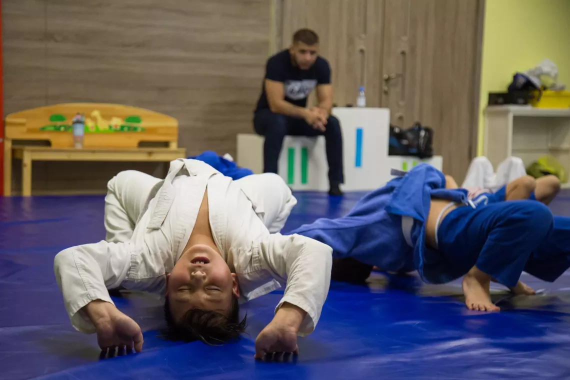 Ten-year-old Yerzhan in Almaty, Kazakhstan warms up before wrestling. There is evidence that both children and teenagers sleep better and feel more rested when they exercise during the day.