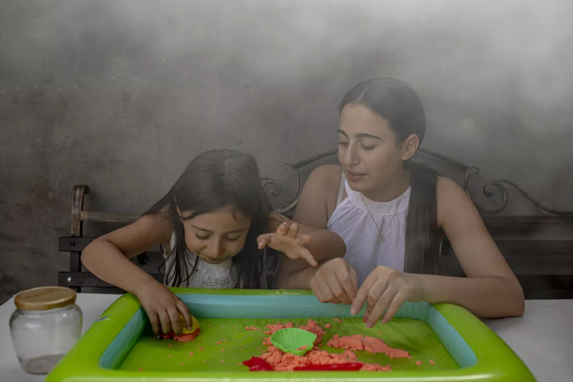 Hasmik Baghdasaryan (right) 16, plays at home with her sister, Maria, 5.