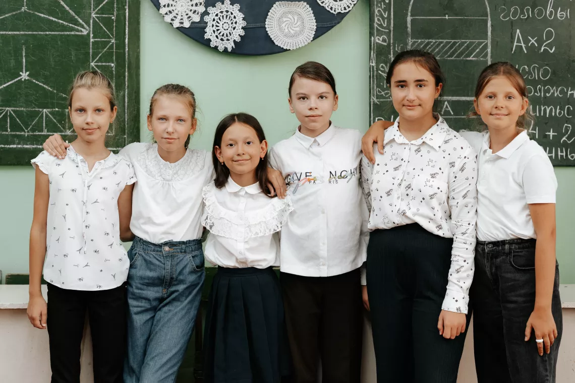 Ten-year-old Darya from Ukraine and her new friends pose for a photo. 