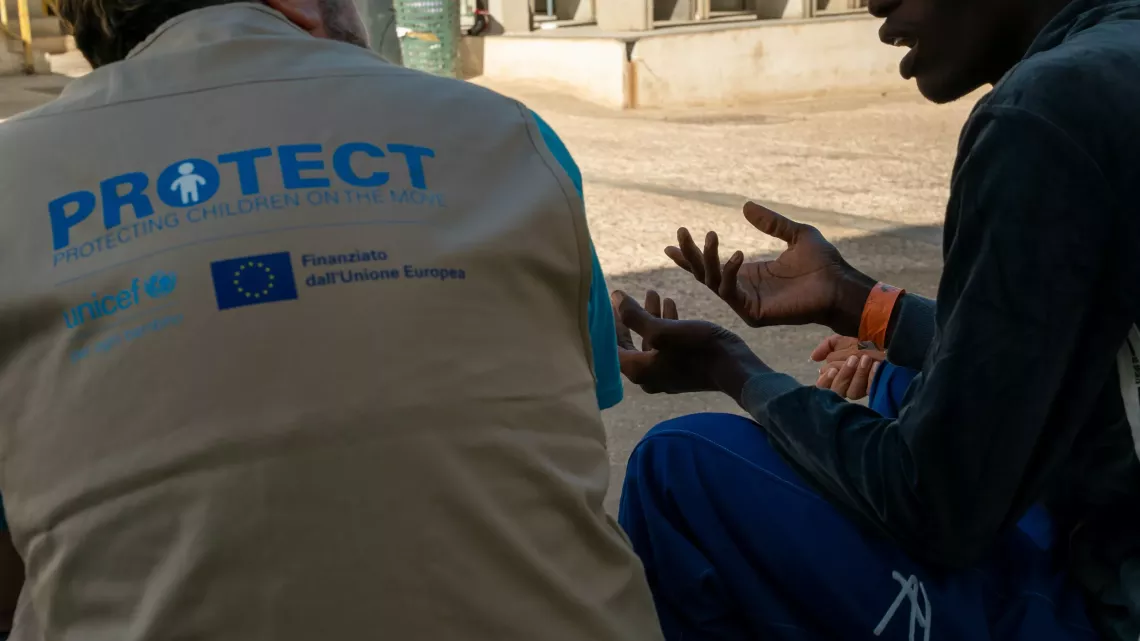During a particularly deadly summer for those attempting  to&nbsp;reach Europe by the dangerous Central Mediterranean Sea route, UNICEF staff members speak with an unaccompanied child at the &lsquo;hotspot&rsquo; reception centre on the island&nbsp;of&nbsp;Lampedusa, Italy. 2023.