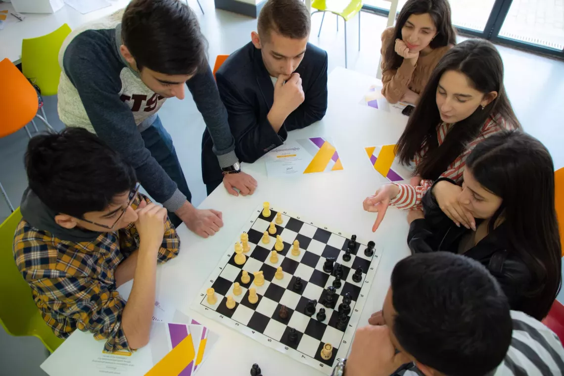 Teenagers play chess in Kapan, Armenia. Research has found that if adolescents do not get the sleep they need, it can affect their concentration and school performance.