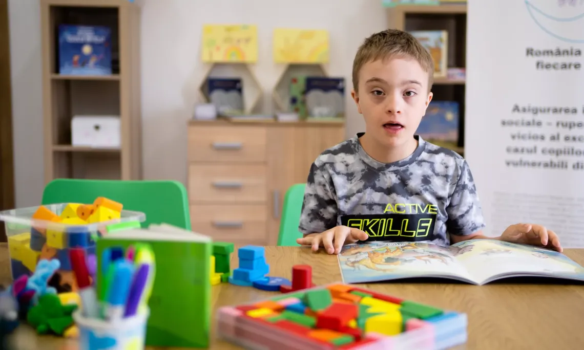 Darius, aged 10, does his homework at the Community Integrated  Centre in Bacau, Romania. The Centre has helped him not only  to&nbsp;acquire new skills, but also to become more relaxed. July 2023