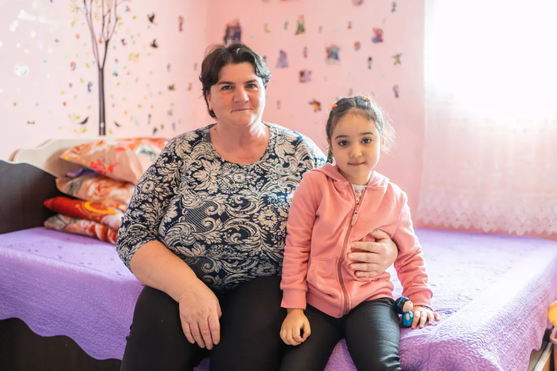 Antonia and her grandmother, Maria, pose inside their home in February 2024. Maria pays particular attention to any signs of respiratory illness in Maria, which can cause the child severe health complications.