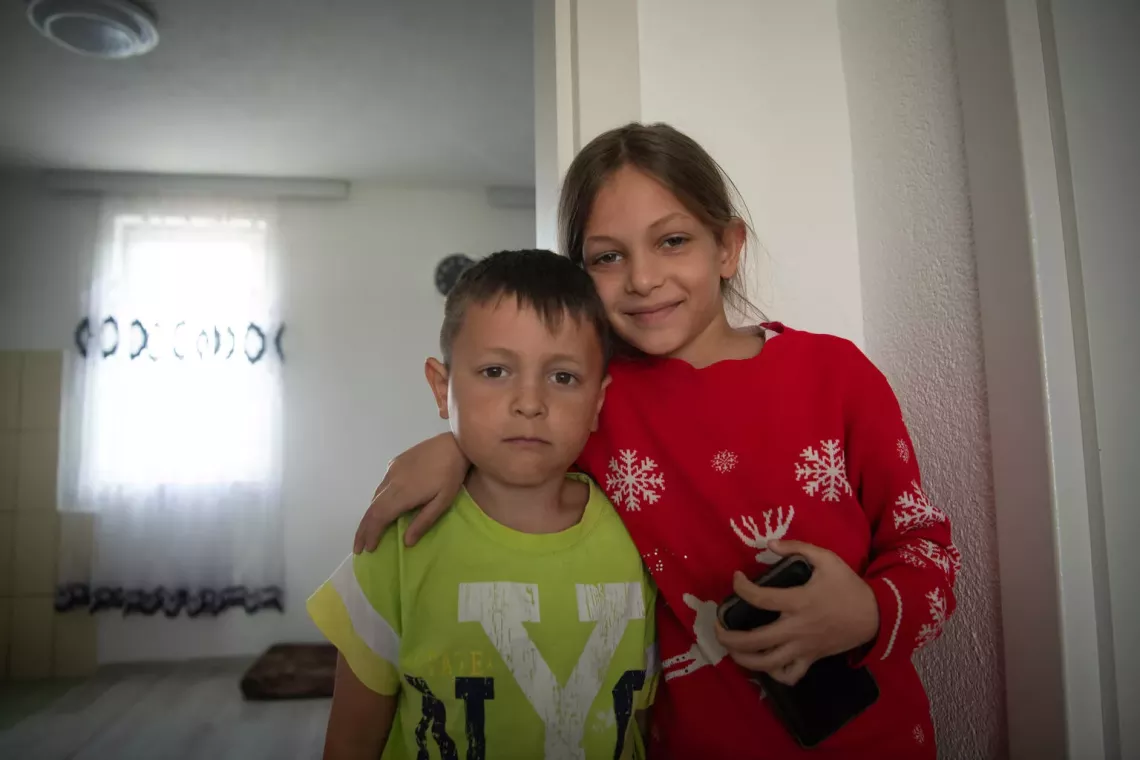 Five-year-old Ismaili and his sister in their home in Obiliq, Kosovo. Ismaili has been hospitalized numerous times with pulmonary disease caused by the coal-powered plant outside his home, March 2024.