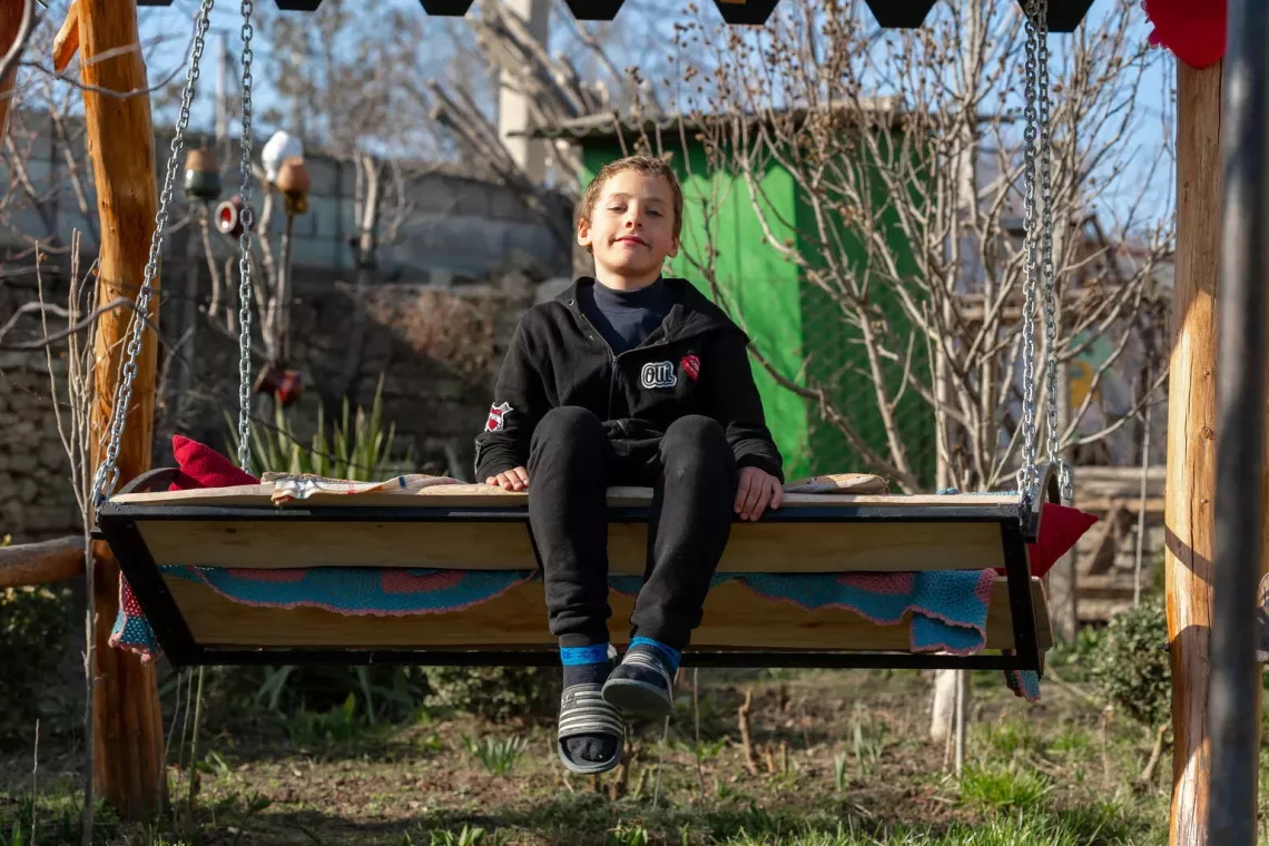 Eleven-year-old Oskar enjoys the fresh air from the house's garden of his foster parents in Moldova.