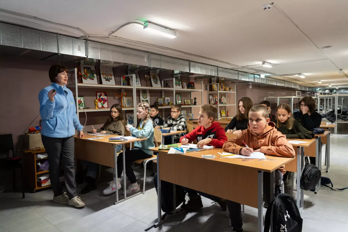 In the bomb shelter beneath a school on the outskirts of Kharkiv, Ukraine, maths teacher Tetiana reassures her students &ldquo;I will come to everyone and explain everything.&rdquo; The school runs catch-up classes to help children of different ages recover learning losses. March 2024.