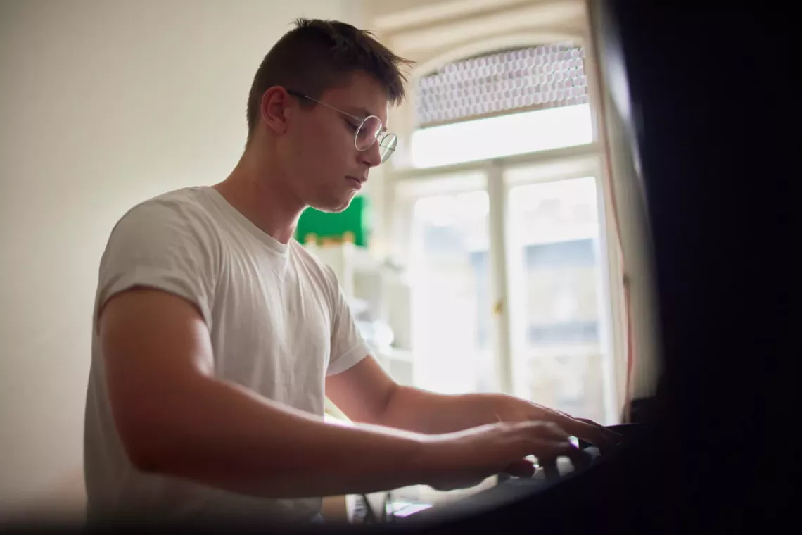 [Nikita playing the piano]