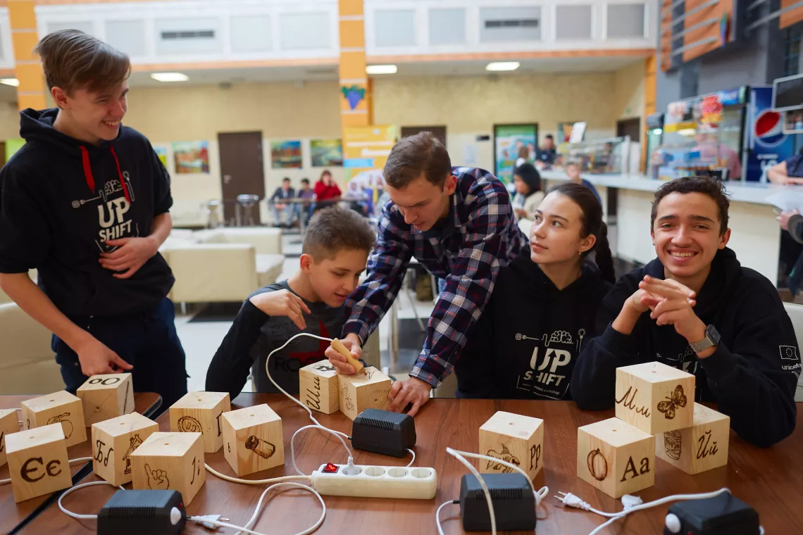 Volodymyr (right) and his team from &ldquo;Hear with the Heart&rdquo; UPSHIFT project delivering a master-class on creating the interactive alphabet cubes in Kharkiv, Ukraine.
