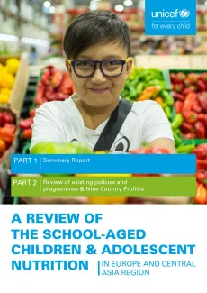 Adolescent boy in front of fruit market. 