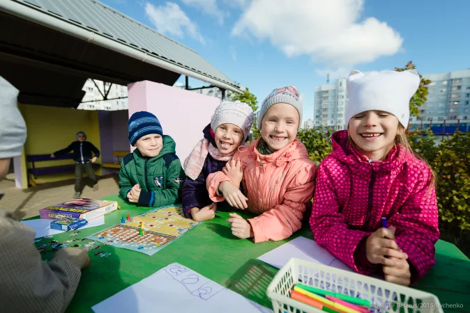 Children engaged in seasonal outdoor activities at ta preschool in Minsk, Belarus.