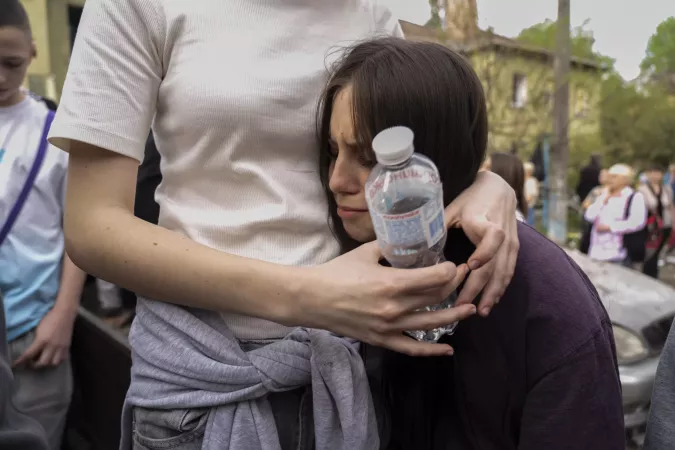 Viktoriia, 17, is comforted by a friend after learning that their 17-year-old companion was found dead beneath the rubble of his home following a missile strike. &ldquo;He was just a good person, really good,&rdquo; said Viktoriia. The attack killed 12 people, including three children, and injured 90 others. Rescue operations continue as teams search for other potential victims.